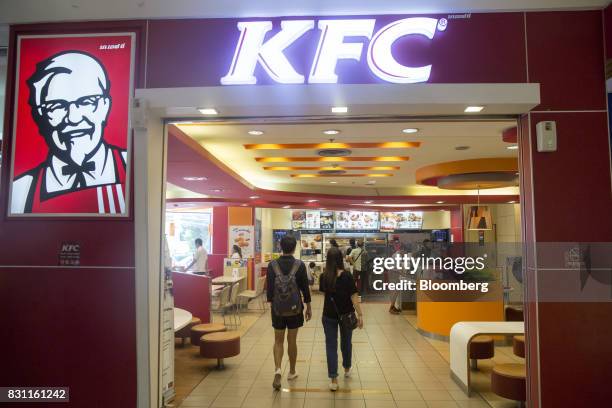 Customers enter a Yum! Brands Inc. KFC restaurant in Bangkok, Thailand, on Friday, Aug. 11, 2017. Thai Beverage, the spirits giant that makes Chang...