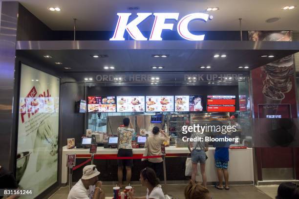 Customers order food at a Yum! Brands Inc. KFC restaurant in Bangkok, Thailand, on Friday, Aug. 11, 2017. Thai Beverage, the spirits giant that makes...