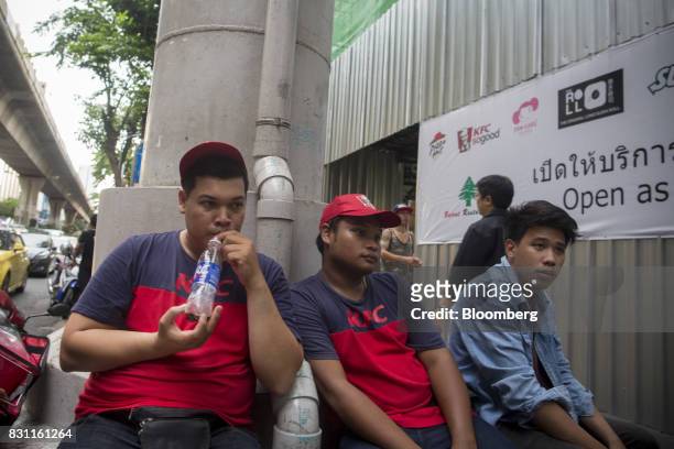 Delivery workers for Yum! Brands Inc. KFC restaurants sit outside a restaurant in Bangkok, Thailand, on Friday, Aug. 11, 2017. Thai Beverage, the...