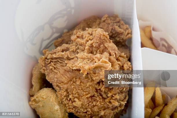 Bucket of Yum! Brands Inc. KFC chicken and french fries are arranged for a photograph in Bangkok, Thailand, on Friday, Aug. 11, 2017. Thai Beverage,...