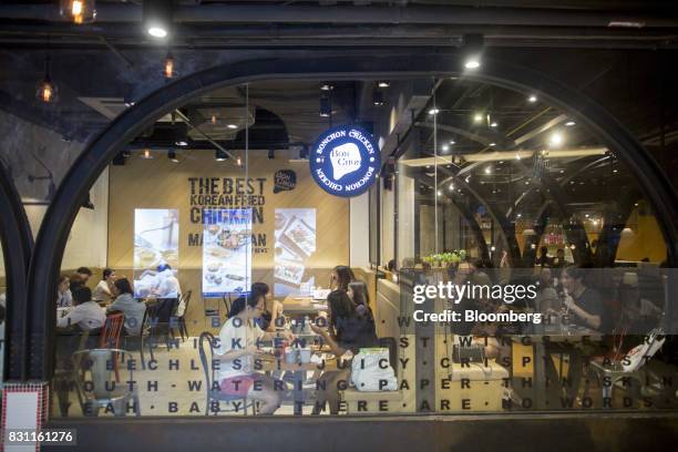 Customers dine at a Bonchon Chicken restaurant in Bangkok, Thailand, on Friday, Aug. 11, 2017. Thai Beverage, the spirits giant that makes Chang beer...