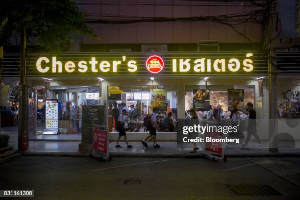 Pedestrians walk past a Chester's Grill restaurant in Bangkok, Thailand, on Friday, Aug. 11, 2017. Thai Beverage, the spirits giant that makes Chang...