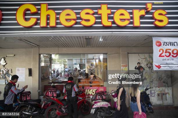 Delivery riders stand outside a Chester's Grill restaurant in Bangkok, Thailand, on Friday, Aug. 11, 2017. Thai Beverage, the spirits giant that...