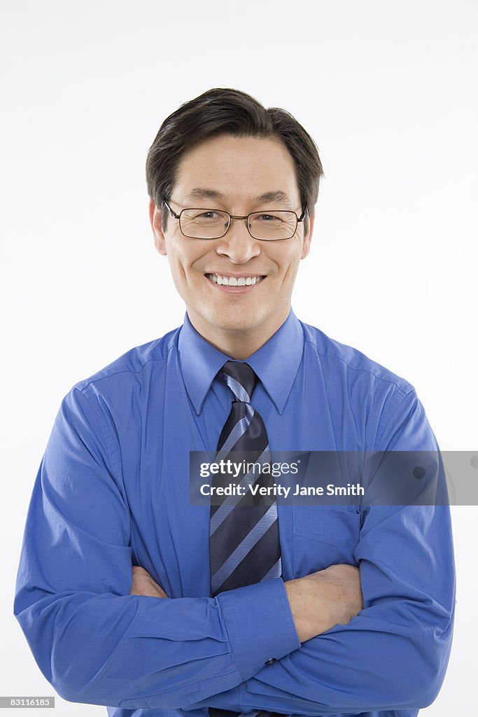 Smiling businessman with arms crossed