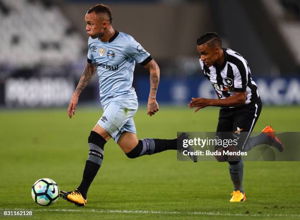 Arnaldo of Botafogo struggles for the ball with Everton of Gremio during a match between Botafogo and Gremio as part of Brasileirao Series A 2017 at...