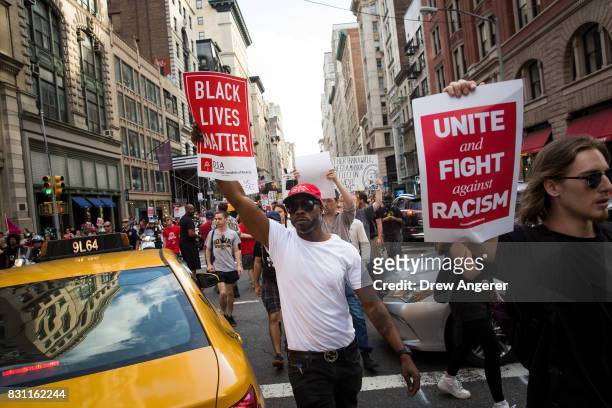 Protestors make their way north on Fifth Avenue as they march against white supremacy and racism, August 13, 2017 in New York City. 32-year-old...