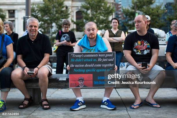 Luke Mueller, center, attends a vigil in downtown Philadelphia on August 13, 2017 in support of the victims of violence at the 'Unite the Right'...