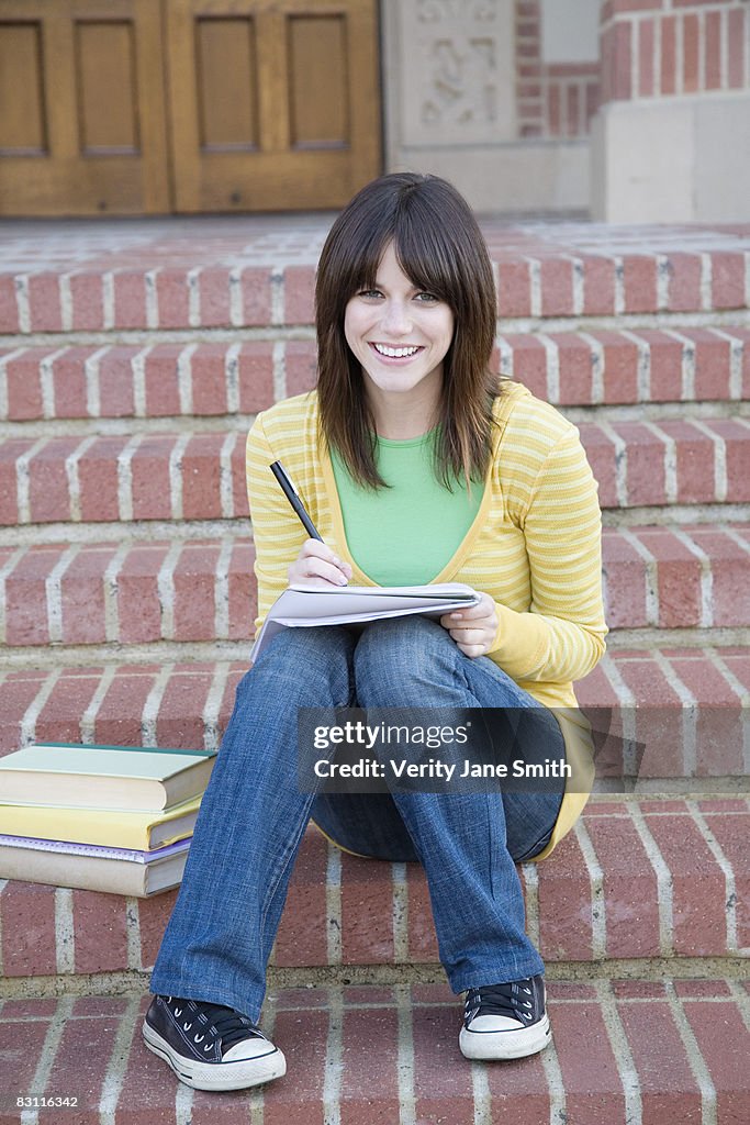 Smiling woman with notebook