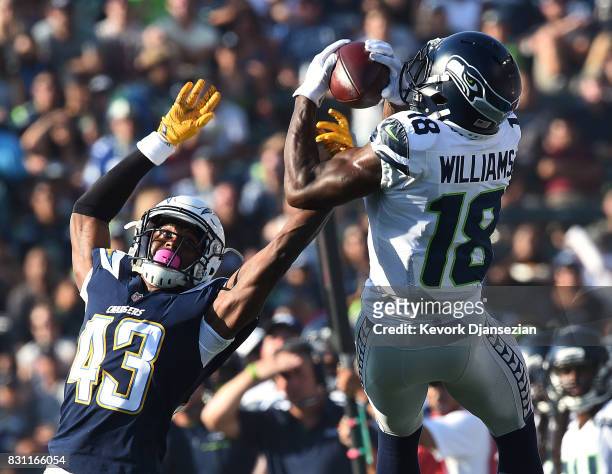 Kasen Williams of the Seattle Seahawks catches a pass against cornerback Michael Davis of the Los Angeles Chargers during the second quarter of their...