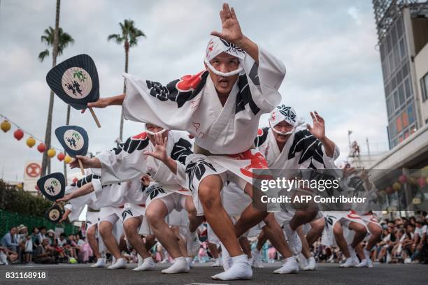 This photo taken on August 13, 2017 shows Eiji Ohmatsudani of the Sasa-ren leading dancers on a street during the Awa Odori festival in Tokushima....