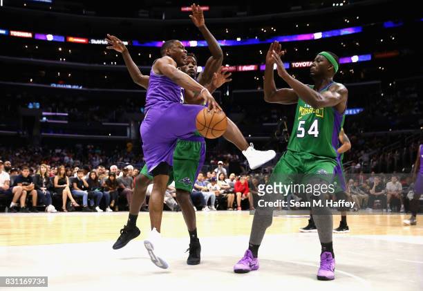 Kareem Rush and Kwame Brown of 3 Headed Monsters defend against Marcus Banks of Ghost Killers during week eight of the BIG3 three on three basketball...