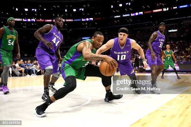 Rashard Lewis of 3 Headed Monsters dribbles around Ivan Johnson and Mike Bibby of Ghost Killers during week eight of the BIG3 three on three...