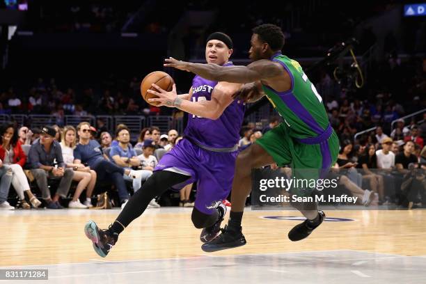 Mike Bibby of Ghost Killers drives past Kareem Rush of 3 Headed Monsters during week eight of the BIG3 three on three basketball league at Staples...