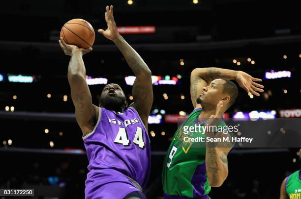 Ivan Johnson of Ghost Ballers drives past Rashard Lewis of 3 Headed Monsters during week eight of the BIG3 three on three basketball league at...