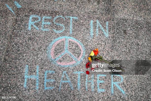 Flowers are laid on a memorial to Heather Heyer that was chalked on the pavement during a demonstration on August 13, 2017 in Chicago, Illinois....