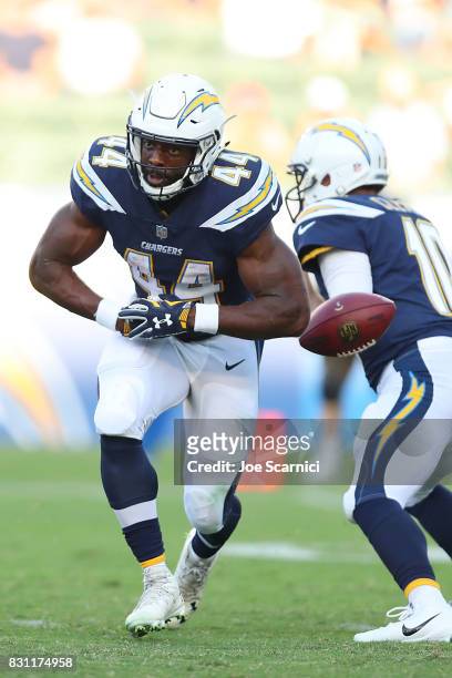 Andre Williams of the Los Angeles Chargers fumbles the ball during a handoff from Kellen Clemens in the second quarter against the Seattle Seahawks...