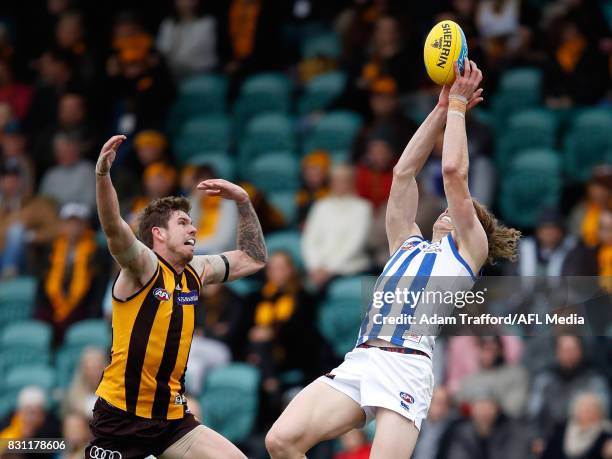 Kaiden Brand of the Hawks and Ben Brown of the Kangaroos compete for the ball during the 2017 AFL round 21 match between the Hawthorn Hawks and the...