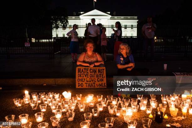 People gather in front of the White House on August 13, 2017 in Washington, DC for a vigil in response to the death of a counter-protestor in the...