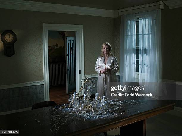 woman looking at fallen chandelier - broken spectacles stock pictures, royalty-free photos & images