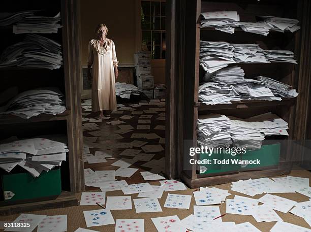 woman standing in room full of sketches - obsessive stockfoto's en -beelden
