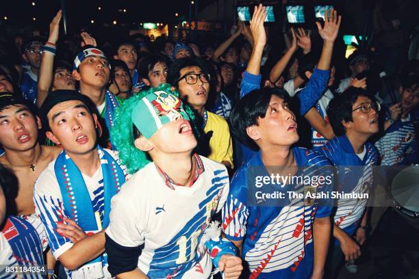 Japanese supporters react as they watch Japan's draw in the 1994 FIFA World Cup Asian Final Qualifier match between Japan and Iraq on October 29,...