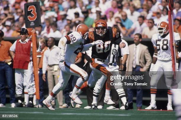 Wide receiver Cris Collinsworth of the Cincinnati Bengals tries to get open despite the efforts of defensive back Hanford Dixon of the Cleveland...