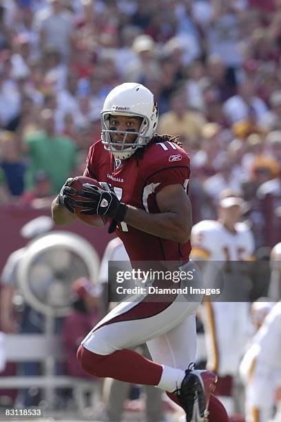 Wide receiver Larry Fitzgerald of the Arizona Cardinals runs with the ball after catching a pass for a touchdown during a game on September 21, 2008...