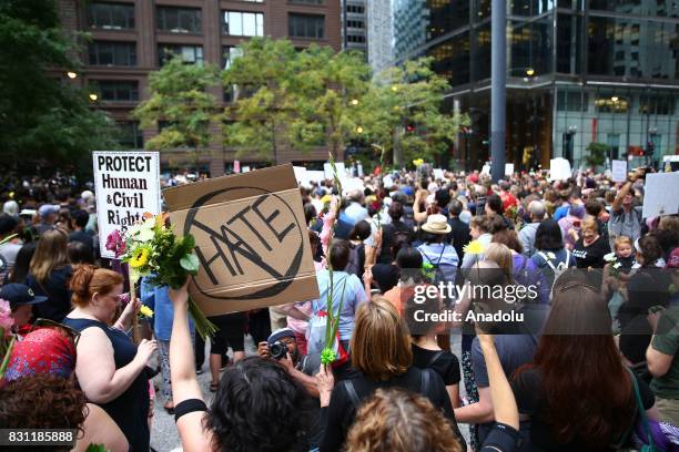 People hold banners during a protest in response to violence erupting at the rally in Charlottesville, at Federal Plaza Square in Chicago, United...