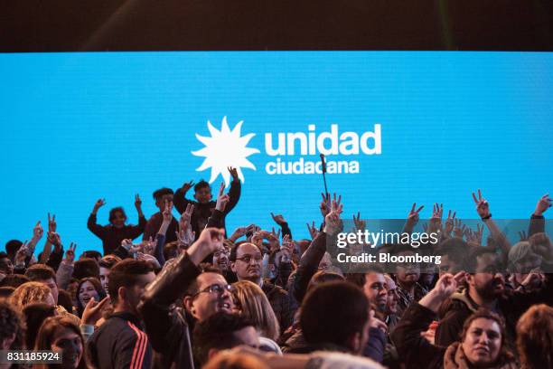 Supporters gesture as they wait for the announcement of election results at the Unidad Ciudadana party headquarters during a primary election in...