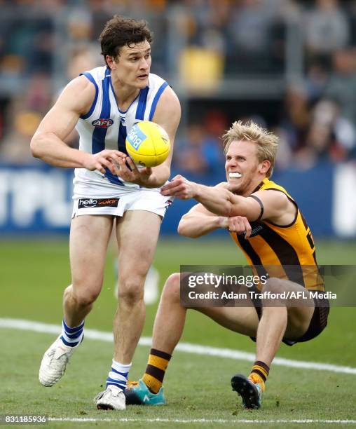 Scott Thompson of the Kangaroos and Will Langford of the Hawks compete for the ball during the 2017 AFL round 21 match between the Hawthorn Hawks and...