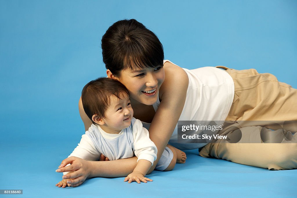 Mother and baby (6-9 months) smiling