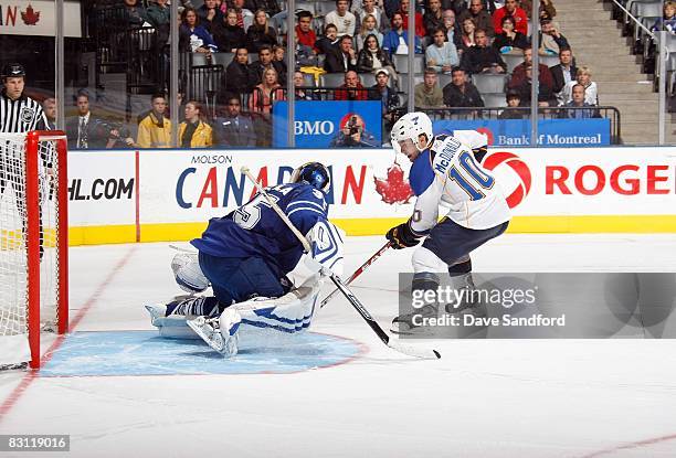 Andy McDonald of the St. Louis Blues skates in for a shot on goal against goaltender Vesa Toskala of the Toronto Maple Leafs during their NHL...