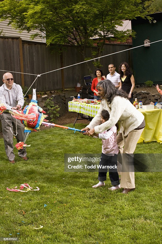 Family hitting pinata