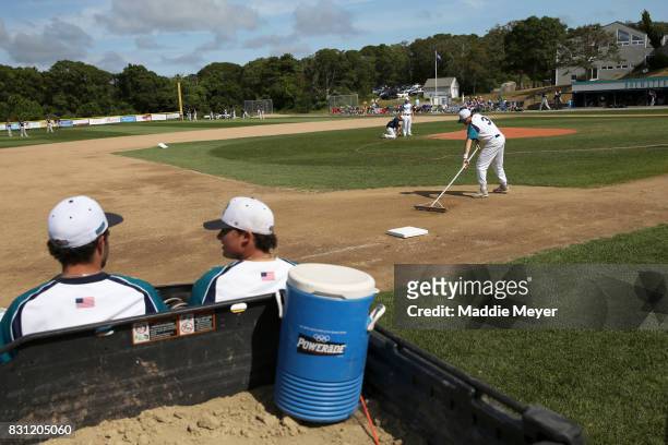 Members of the Brewster Whitecaps prepare the field before game one of the Cape Cod League Championship Series against the Bourne Braves at Stony...