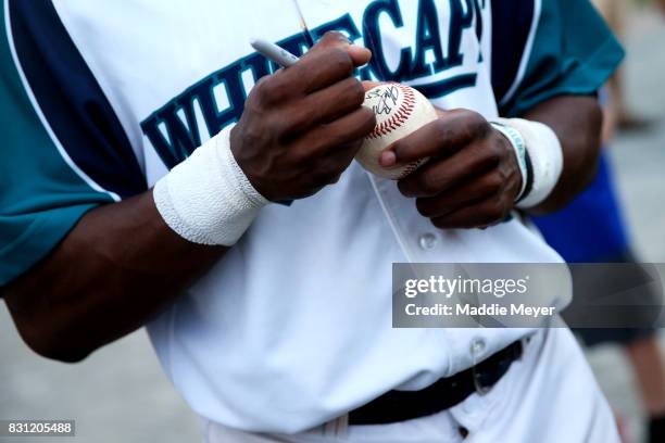 Martin Costes of the Brewster Whitecaps signs autographs after game one of the Cape Cod League Championship Series at Stony Brook Field on August 11,...