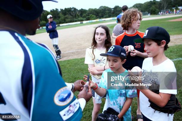 Martin Costes of the Brewster Whitecaps signs autographs after game one of the Cape Cod League Championship Series at Stony Brook Field on August 11,...