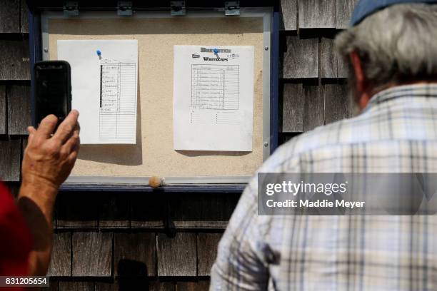 Fans take pictures of the starting lineups of the Bourne Braves and the Brewster Whitecaps before game three of the Cape Cod League Championship...
