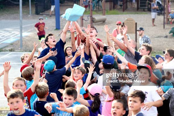 Young fans reach for a free tee shirt during game one of the Cape Cod League Championship Series at Stony Brook Field on August 11, 2017 in Brewster,...