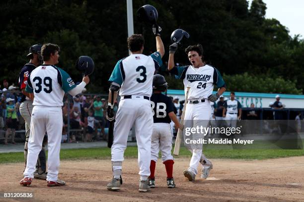 Hunter Bishop, right, celebrates with Kyle Datres and Nicholas Dunn during game one of the Cape Cod League Championship Series against the Bourne...