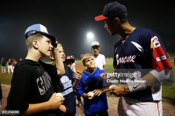 Lyle Lin of the Bourne Braves signs autographs for fans after game two of the Cape Cod League Championship Series at Doran Park on August 12, 2017 in...