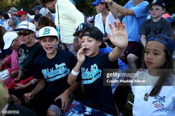 Young fans cheer on the Brewster Whitecaps during game three of the Cape Cod League Championship Series against the Bourne Braves at Stony Brook...