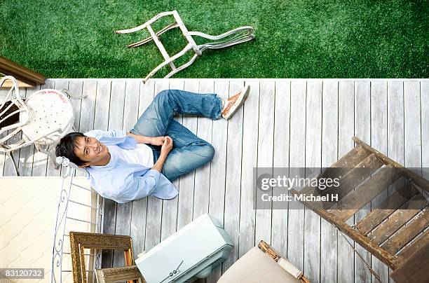 man is sitting on wood floor in  garden - michael sit stock pictures, royalty-free photos & images