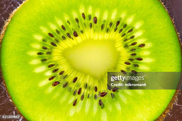 kiwi fruits - kiwifruit or chinese gooseberry close up - kiwi fruit stock pictures, royalty-free photos & images