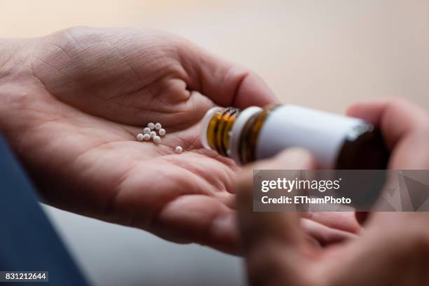 homeopathic pills (globules) - homeopathic medicine stock pictures, royalty-free photos & images