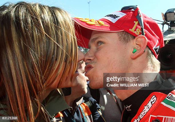 Australian Casey Stoner kisses his wife Adriana after qualifying on pole position for the Australian MotoGP at the Phillip Island track, some 150...