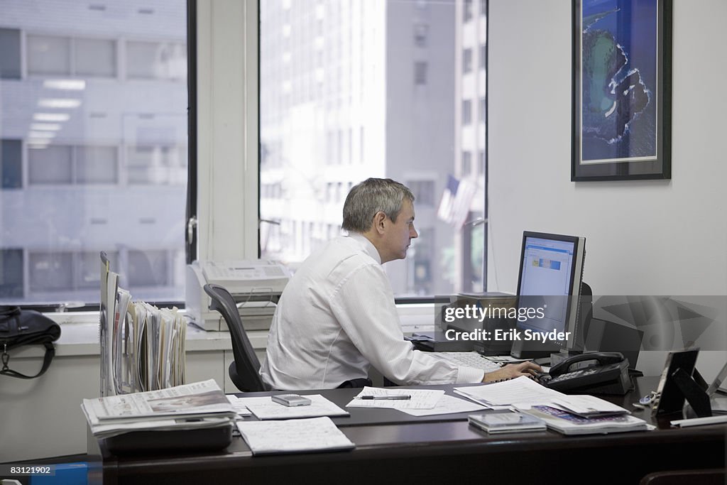 Man in office using computer