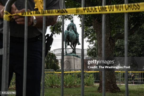 Charlottesville police hang police tape on barricades around Emancipation Park, recently renamed from Lee Park, in front of a controversial statue of...