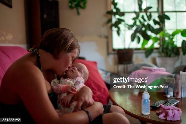 Jennifer Kostoff kisses her 4-month-old daughter, Rikki, at her Granite City, Illinois, home on July 26, 2017. Kostoff became pregnant when she...