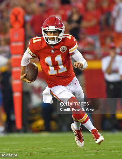 Quarterback Alex Smith of the Kansas City Chiefs rushes for a first down against the San Francisco 49ers during the first half of a preseason game on...