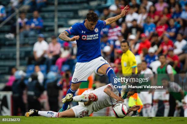 Rodrigo Salinas of Toluca struggles for the ball against Gabriel Penalba of Cruz Azul during the 4th round match between Cruz Azul and Chivas as part...